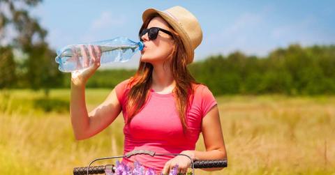 Woman drinking water from a plastic bottle during summer. (Representative Cover Image Source: Freepik | Gpointstudio)