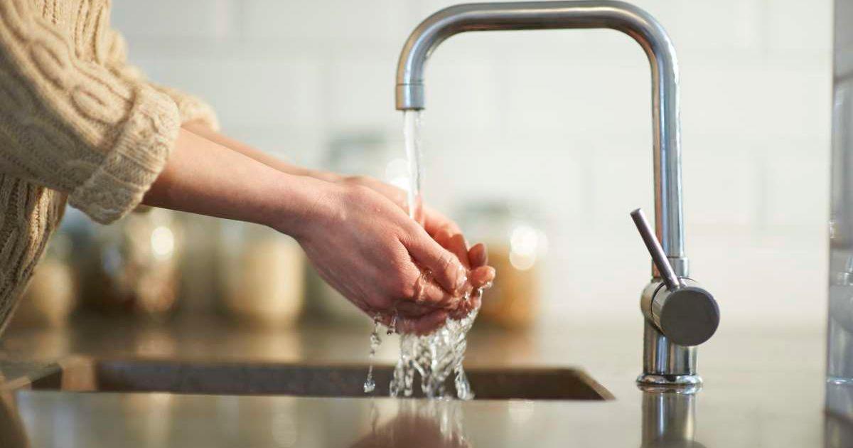 A woman washes her hands in the kitchen sink, close up. (Representative Cover Image Source: Getty Images | Dougal Waters)