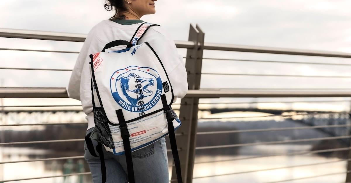 Woman wears Torrain backpack made from upcycled cement