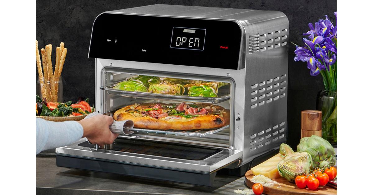 stainless steel air fryer oven with a person removing a pizza