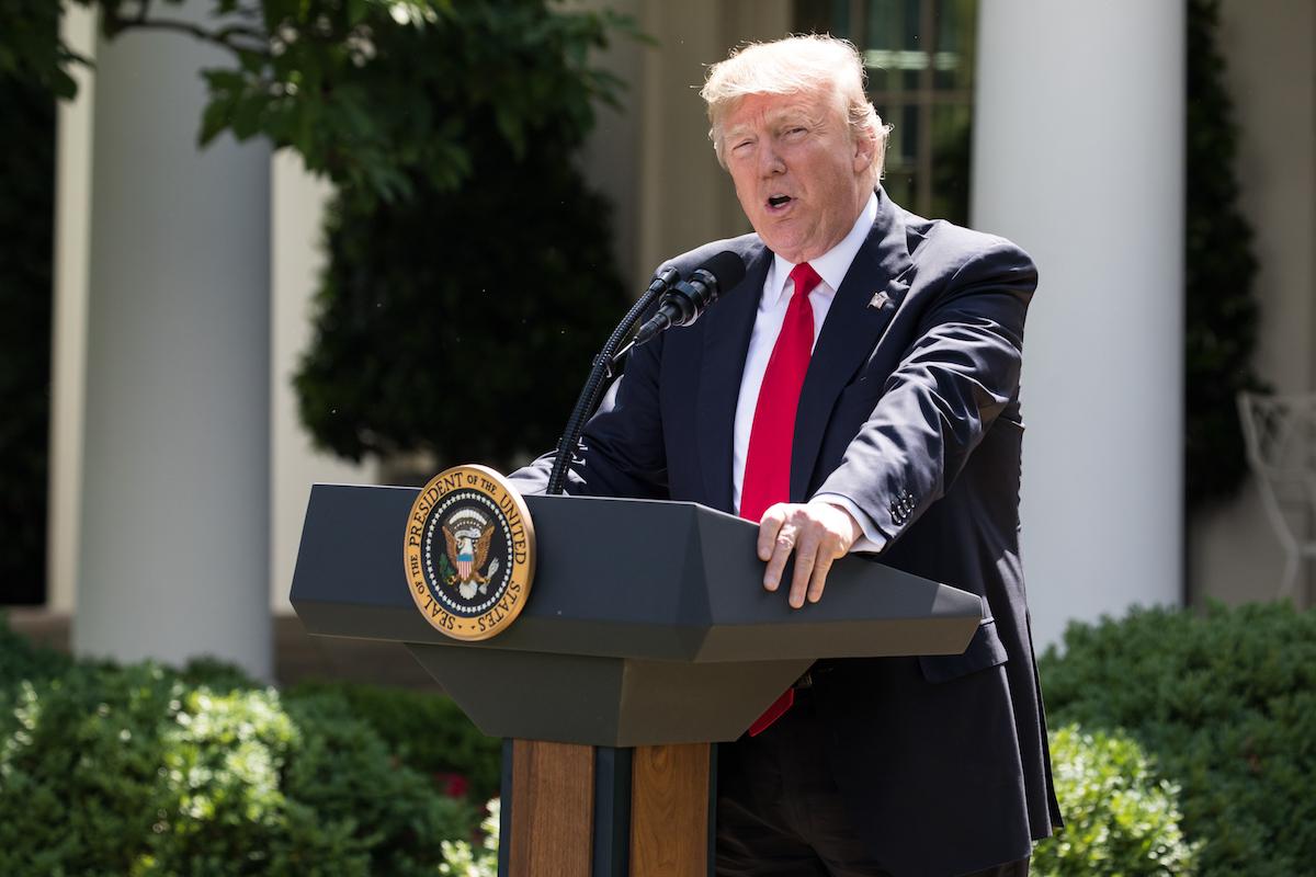 Donald Trump stands at a podium outside the White House. 