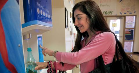 Mary Bradford, a sophomore wearing a pink shirt, refills her water bottle at the FloWater dispenser during lunch break at San Mateo High School in San Mateo, California.