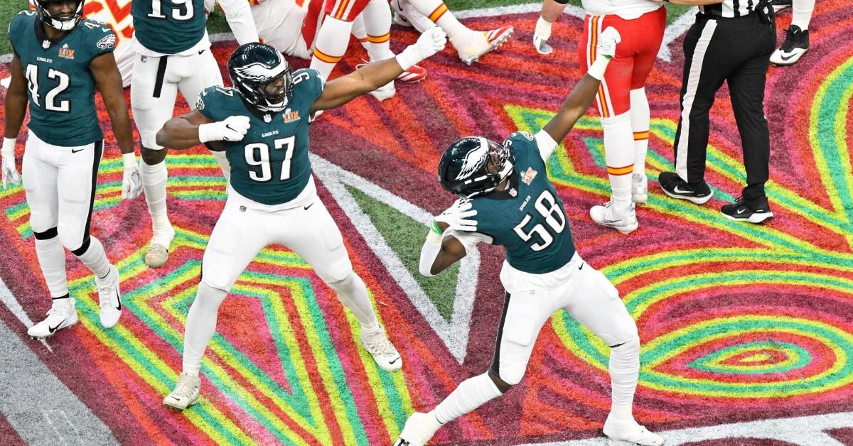 The Philadelphia Eagles celebrate by dancing on the pink, red, green, and yellow field during their Super Bowl win