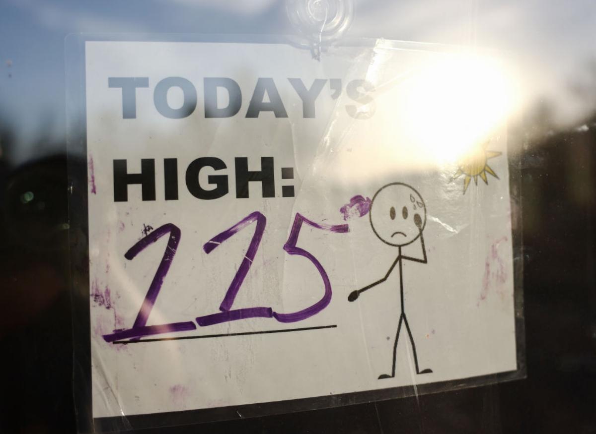 handwritten sign stating today's high temperature is 115 degrees