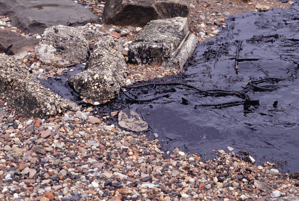 An oil spill on a riverbank