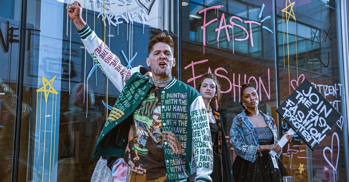 Three people participate in protest with a sign that reads "join the fast fashion protest."