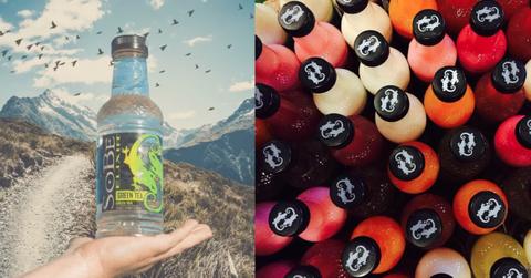 A hand holding a Green Tea flavored SoBe drink in front of a mountain background(left) next to a photo of an aerial view of SoBe bottles with the white lizard logo on the black caps.