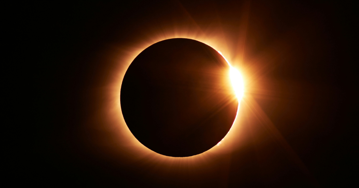 A solar eclipse featuring a sun flare off the right side