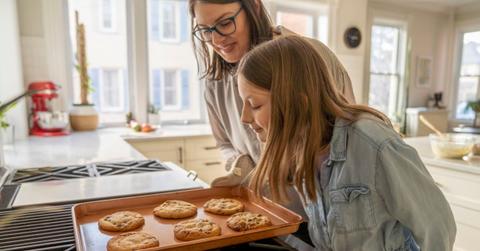 Mother and daughter baking chocolate-chip cookies in the kitchen (Representative Cover Image Source: Getty Images | FatCamera)