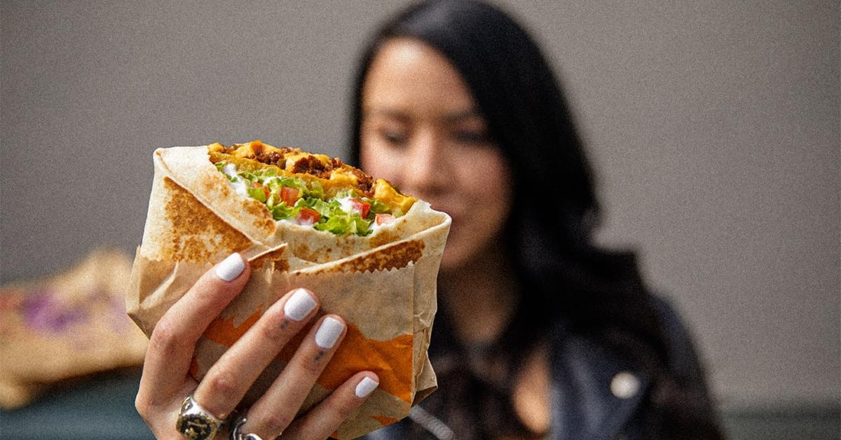 Woman holding a Vegan Crunchwrap.