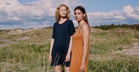 Photo of two women standing in a field wearing Organic Basics clothing