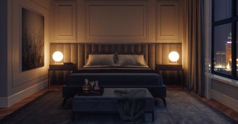 A hotel room in the city with minimal lighting.