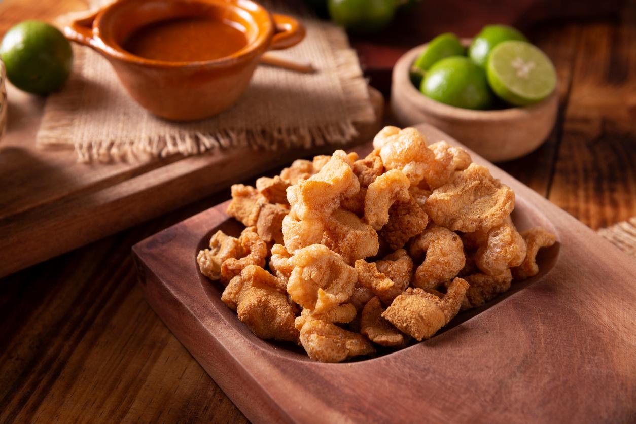 Chicharrones, a traditional Mexican snack, is served with lemon juice and red hot chili sauce.