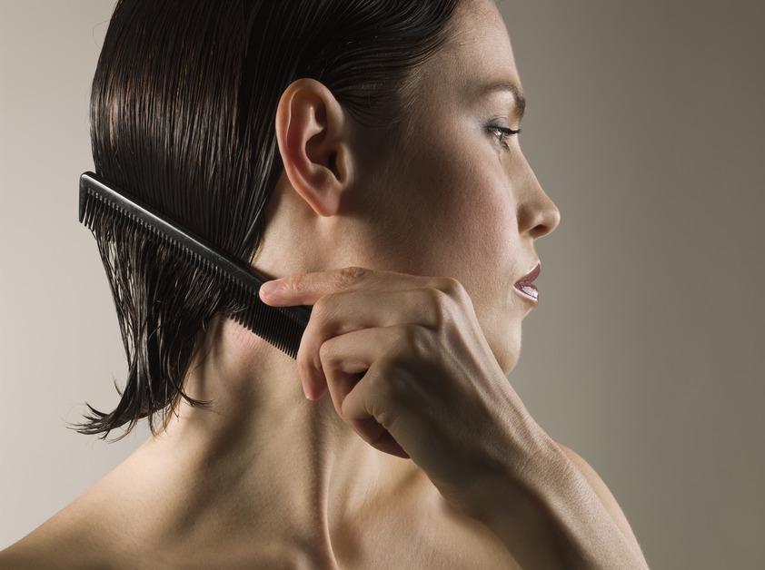 Woman combing hair