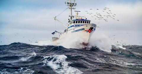 The Northwestern sails on the ocean while surrounded by birds