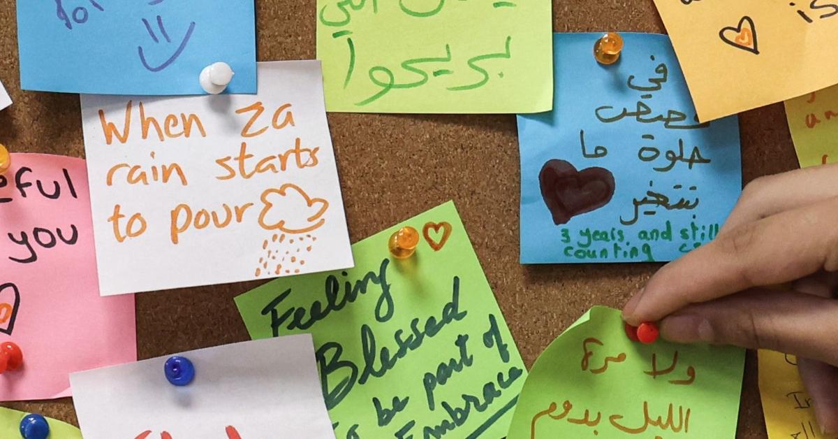 A woman places a note on a post-it board at the offices of Embrace in Lebanon's capital Beirut 