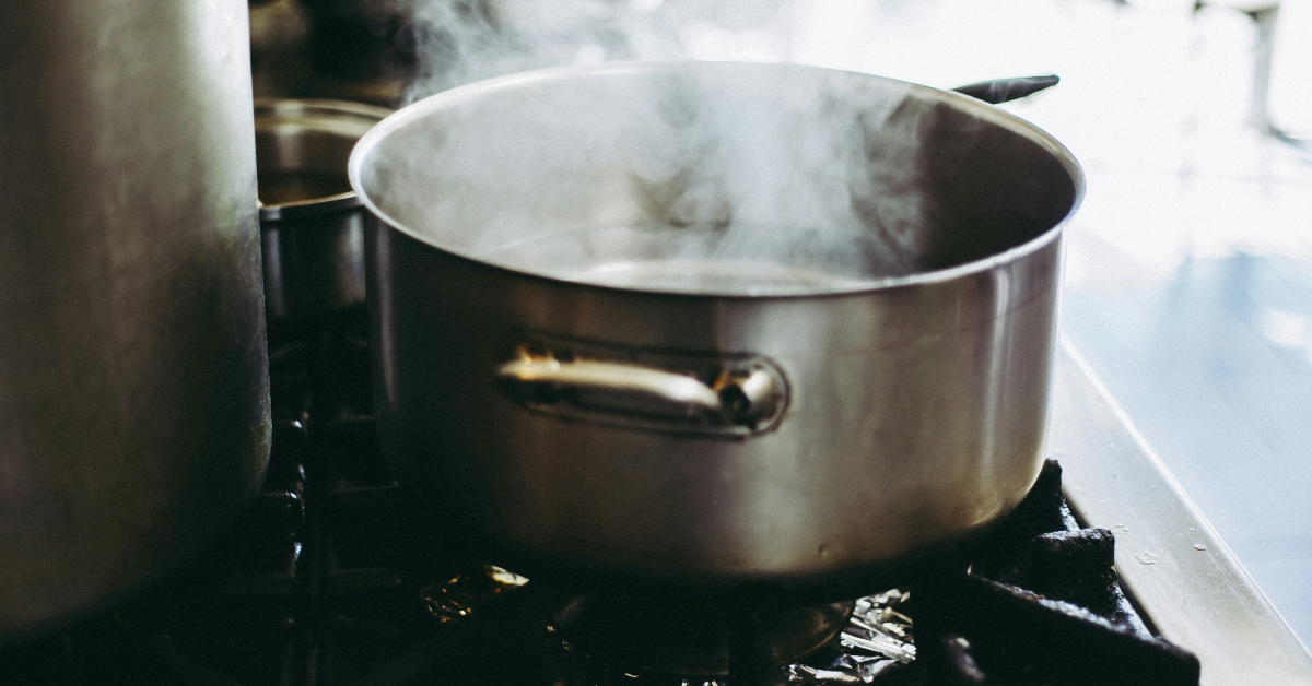 A pot of boiling water sits on the stove