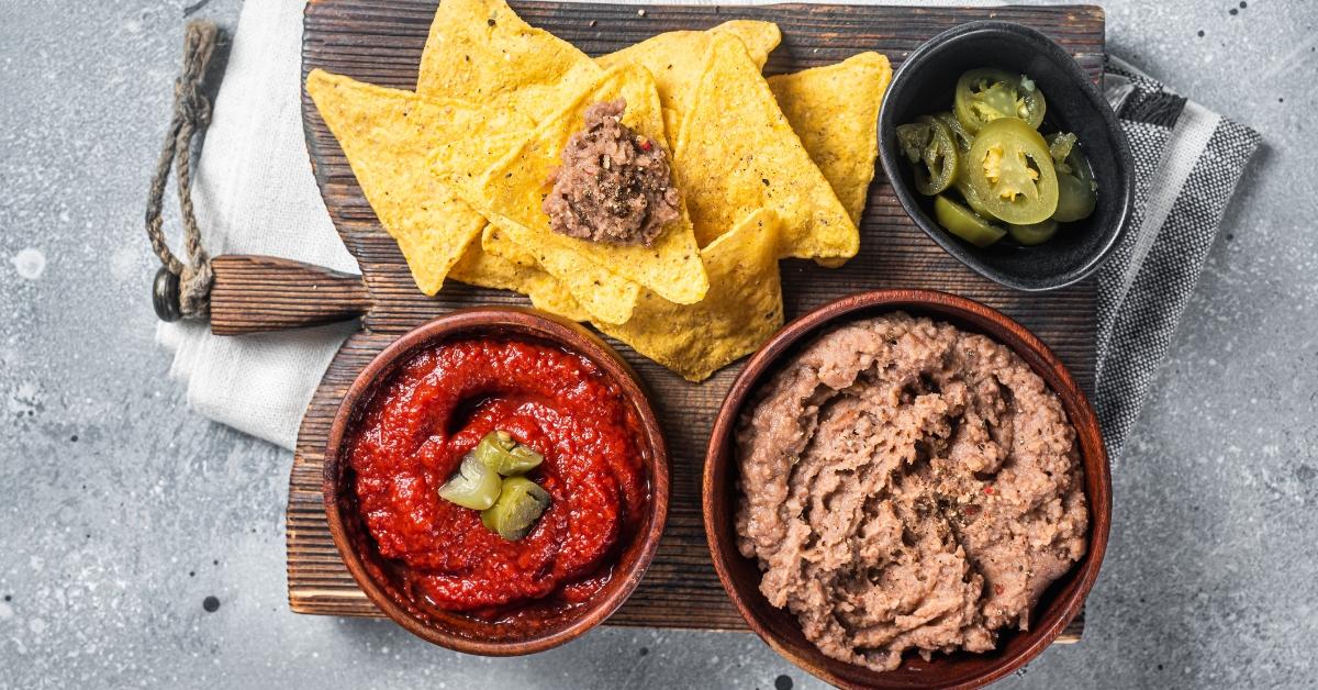 Refried beans and other fixings for nachos. 