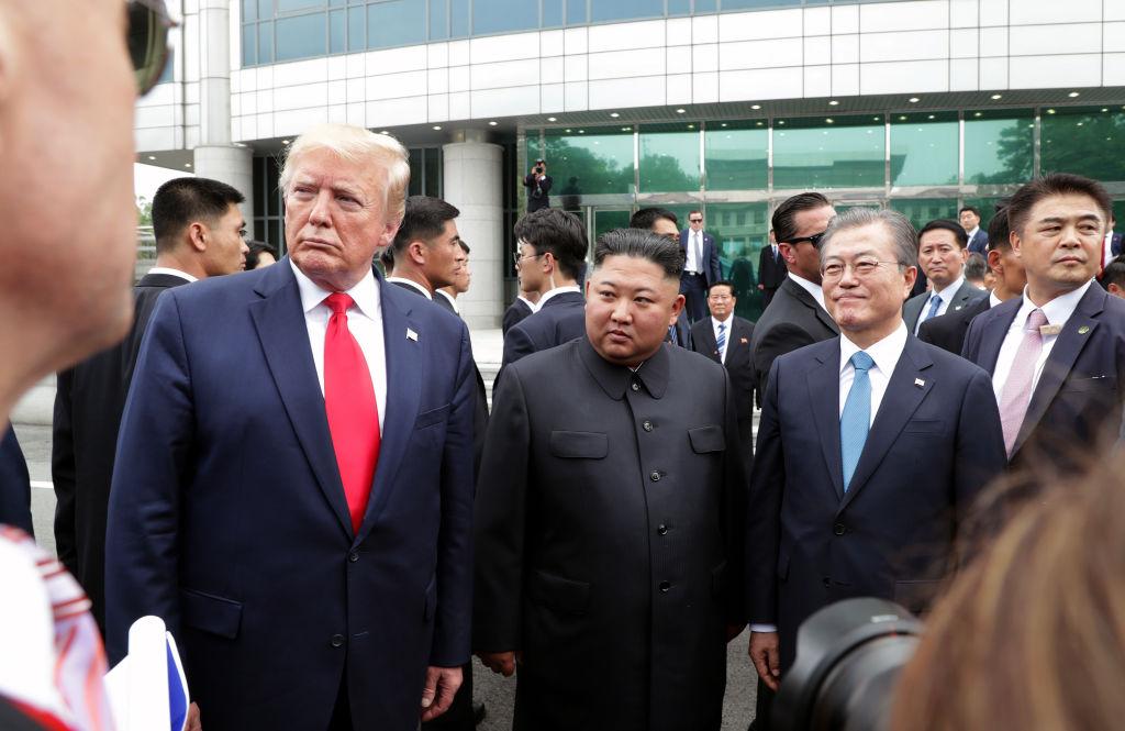 North Korean leader Kim Jong Un, former U.S. President Donald Trump, and South Korean President Moon Jae-in stand together inside the demilitarized zone separating South and North Korea in June 2019.