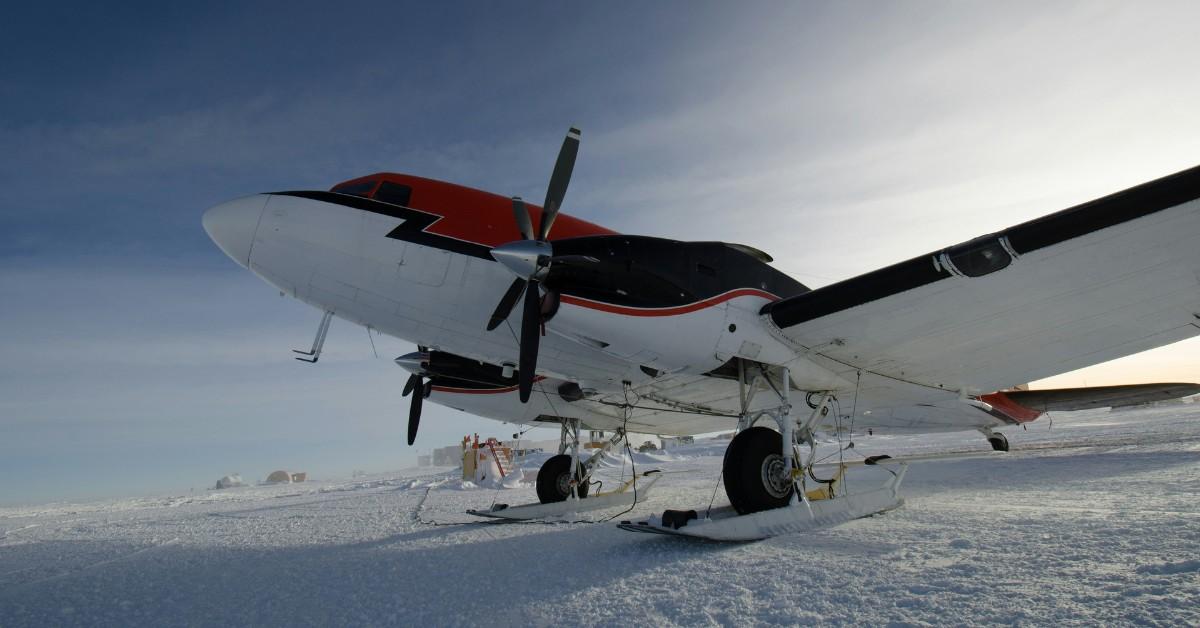 A plane outfitted with skis sits in the snow in Antarctica 