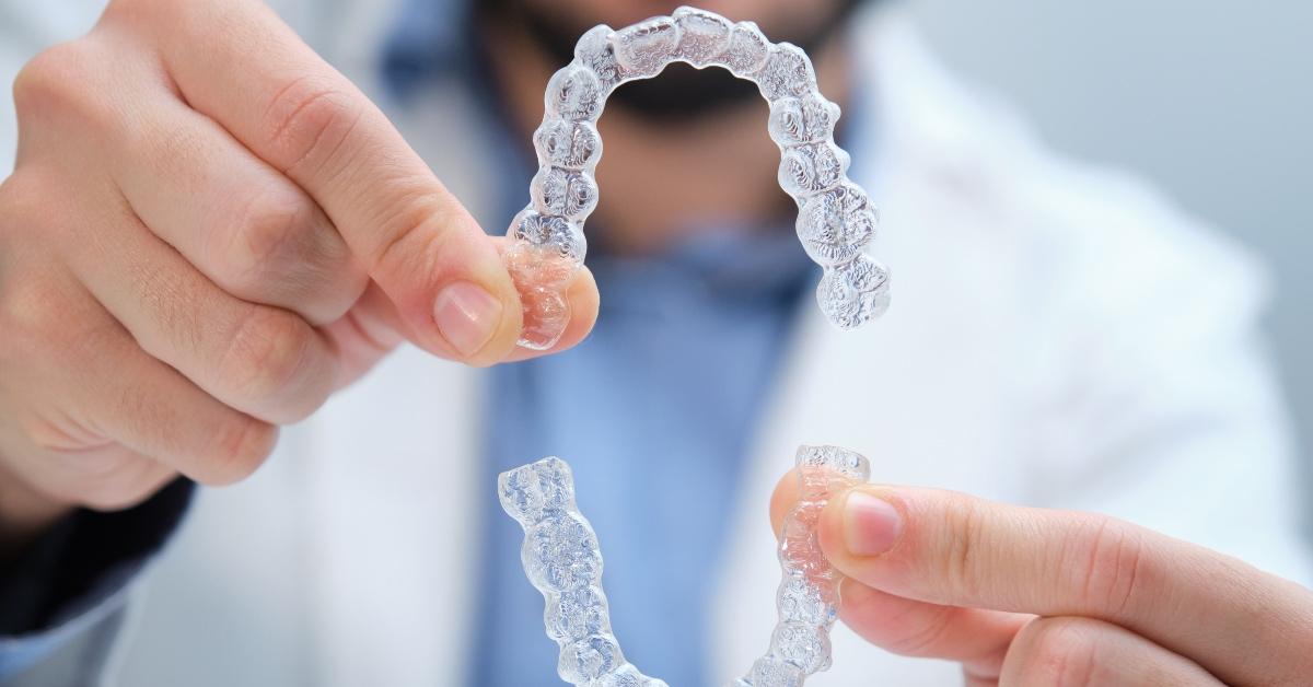 Dentist creating mold of patient's mouth.