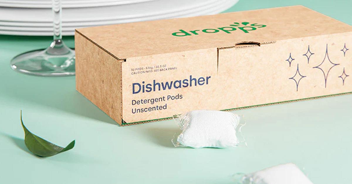 Dropps Dishwasher Detergent: Ultra Concentrated Pods in a box on a table with dishes and a wine glass.