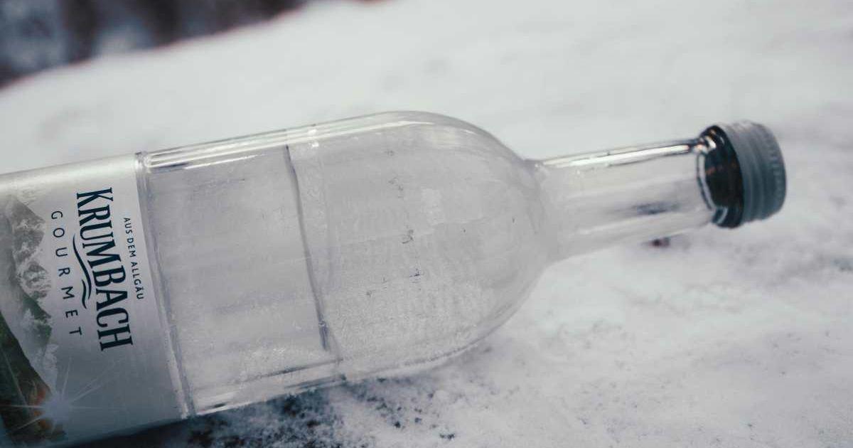 A bottle of mineral water lying on a sheet of snow (Representative Cover Image Source: Pexels | Maria Geller)