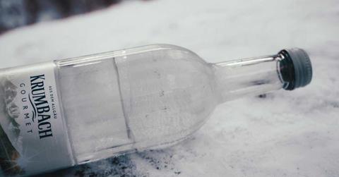 A bottle of mineral water lying on a sheet of snow (Representative Cover Image Source: Pexels | Maria Geller)