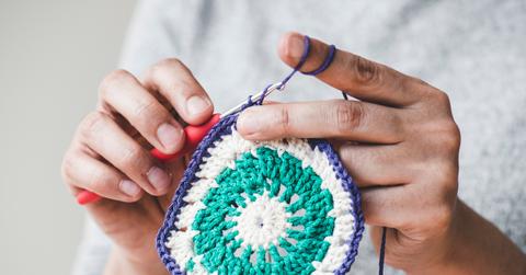 Close up of someone working on a crochet project.