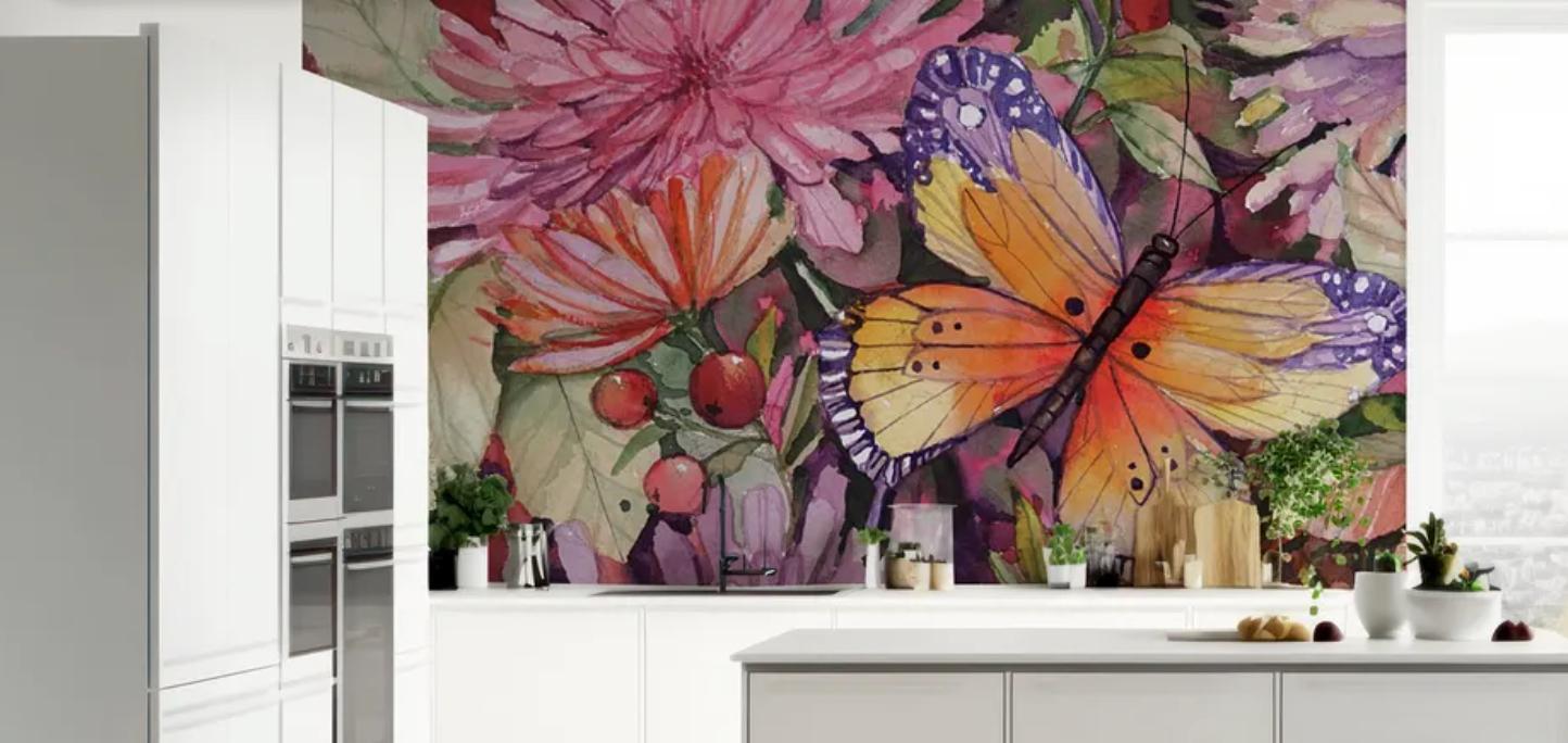 Mural-style wallpaper on the wall of an all-white kitchen. 