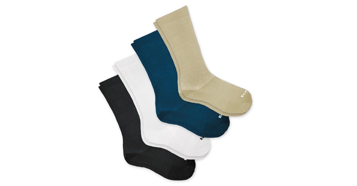 Four pairs of compression socks in black, white, blue, and tan