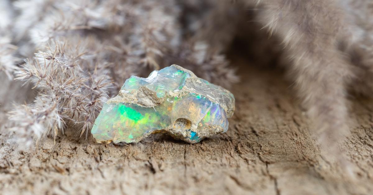 Photo of a boulder opal gemstone on natural wood