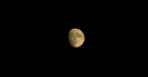 A partially eclipsed full harvest moon in the night sky