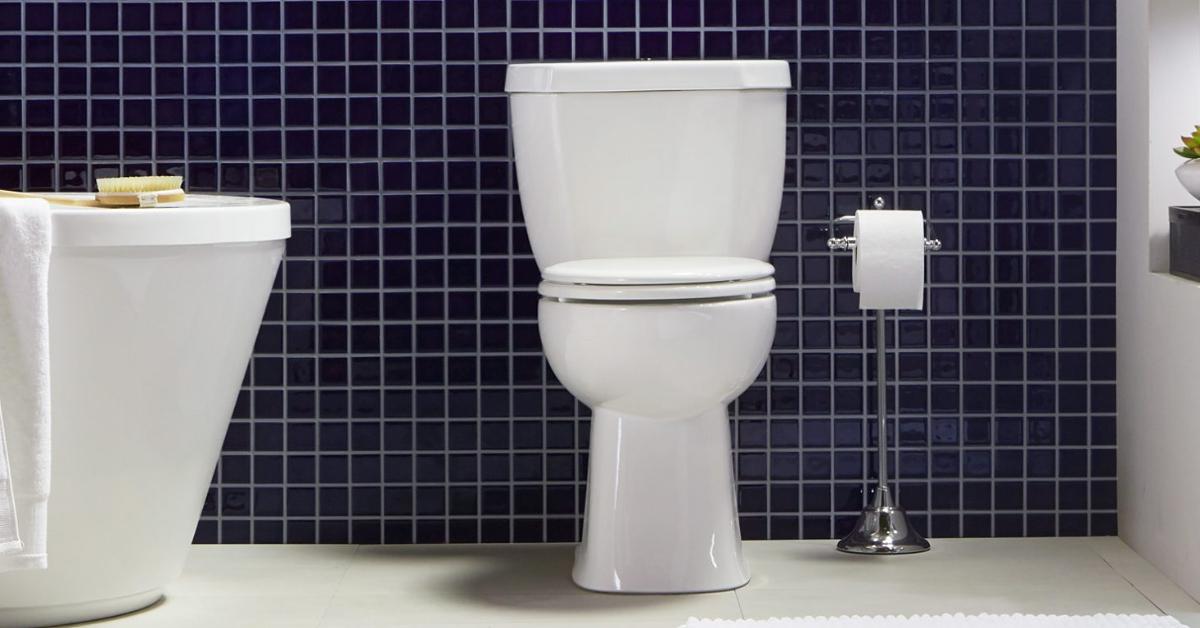 Photo of Niagara's Stealth Two-Piece Ultra-High-Efficiency Single Flush Elongated Toilet in a bathroom with navy blue wall tiling