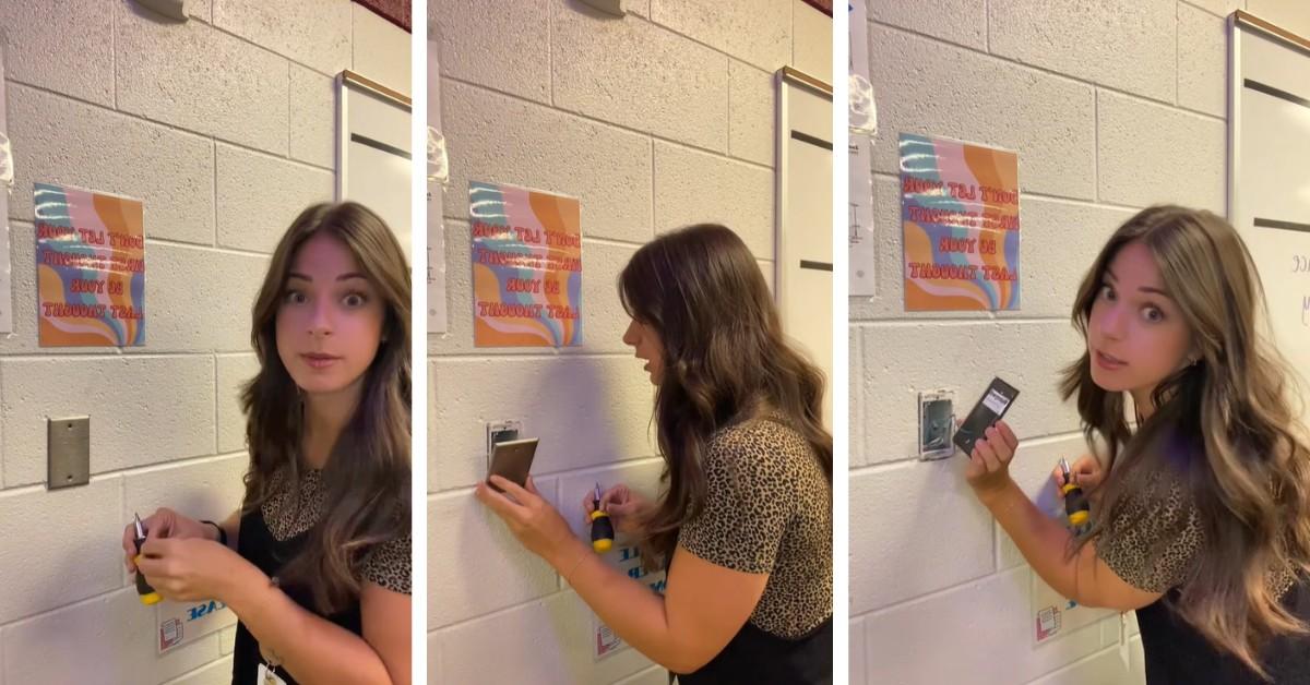 A teacher removes the wall plate in her classroom to prove that it's a sensor for her school's HVAC system