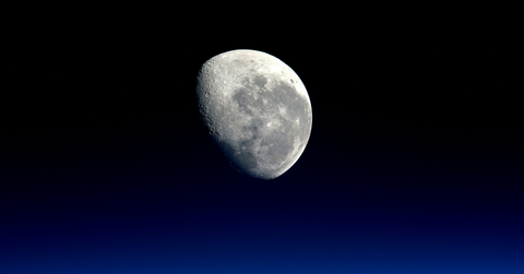 The craters of the moon are visible despite it being slightly in shadows