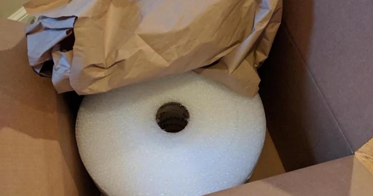 bubble wrap in a large box, filled with paper packaging.