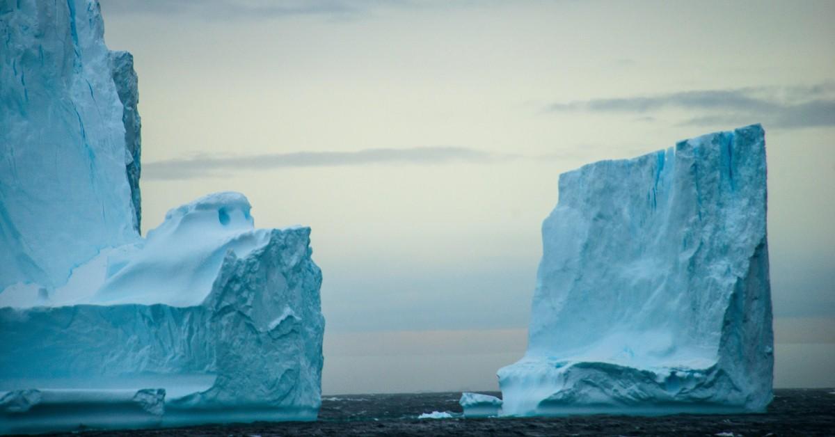 Two icebergs float in the open ocean