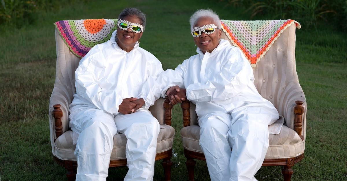 Donna Dear and Paulette Greene wear all-white outfits, sitting in two armchairs at Mt. Pleasant Acres Farms