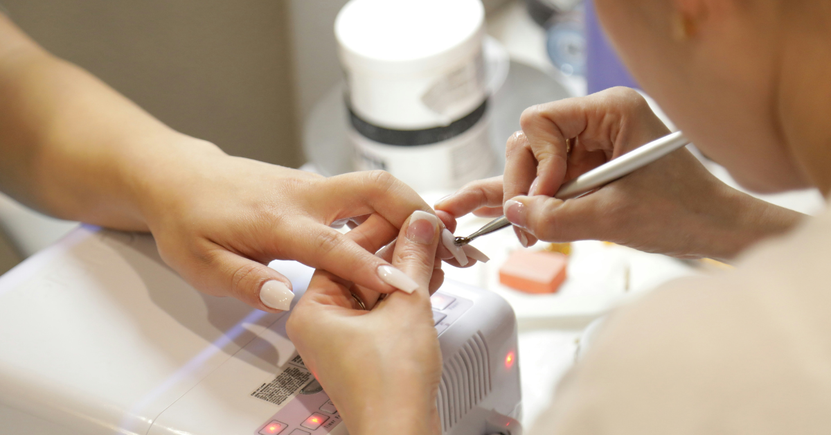 A woman gets her nails done at a salon