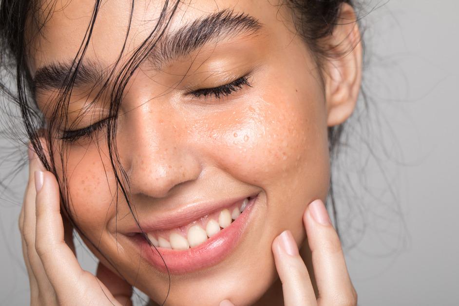 A close up photo of a woman with clear skin. 