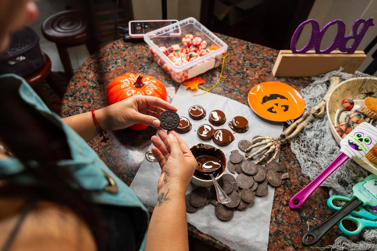 Person making homemade halloween-themed treats.