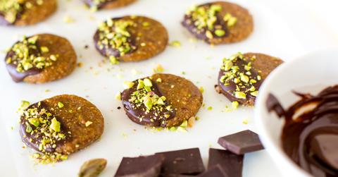 Pistachio and chocolate cookies on a table.
