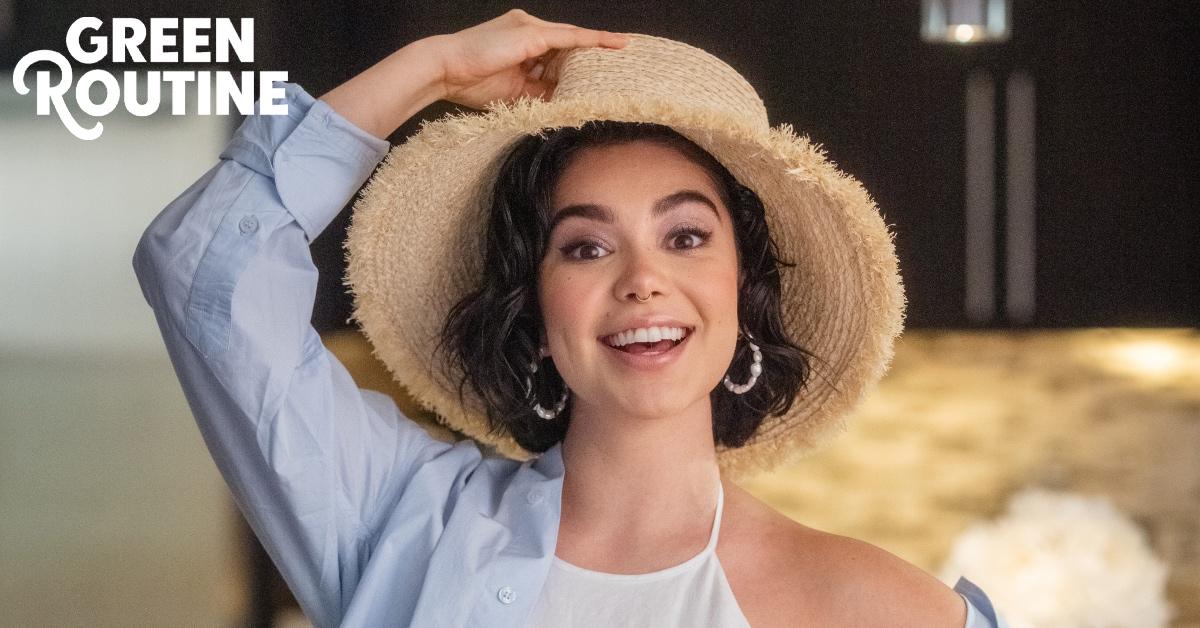 Auli'i Cravalho smiling and wearing a hat.