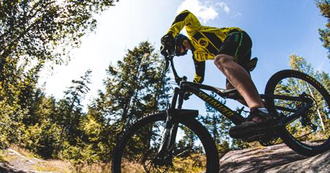 Person riding downhill on a mountain bike.