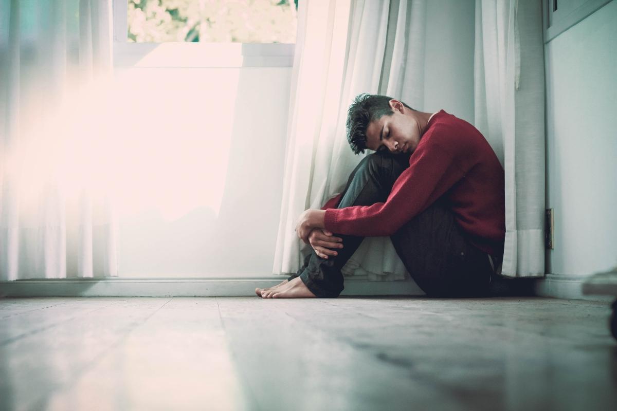 Depressed man sitting on the floor