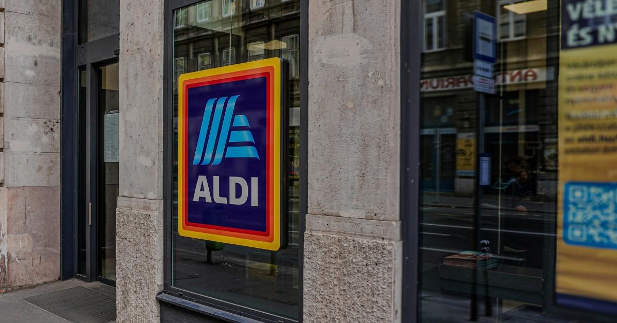 An Aldi sign hangs from the front of a concrete building