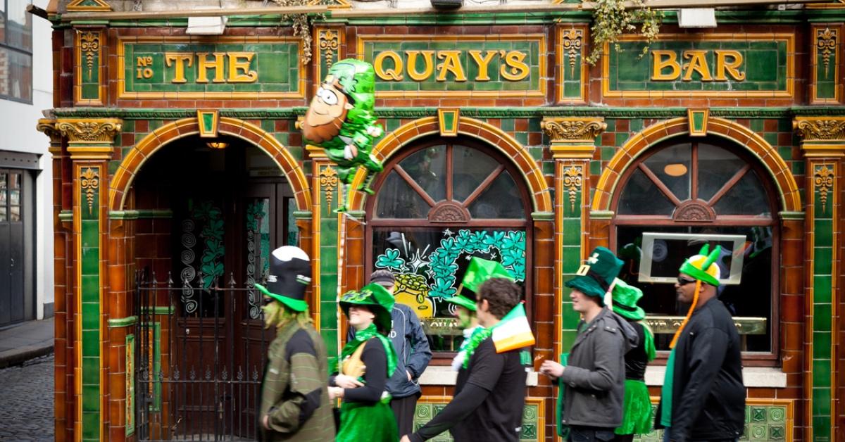 Group of people celebrating St. Patrick's Day at Temple Bar in Dublin, Ireland.