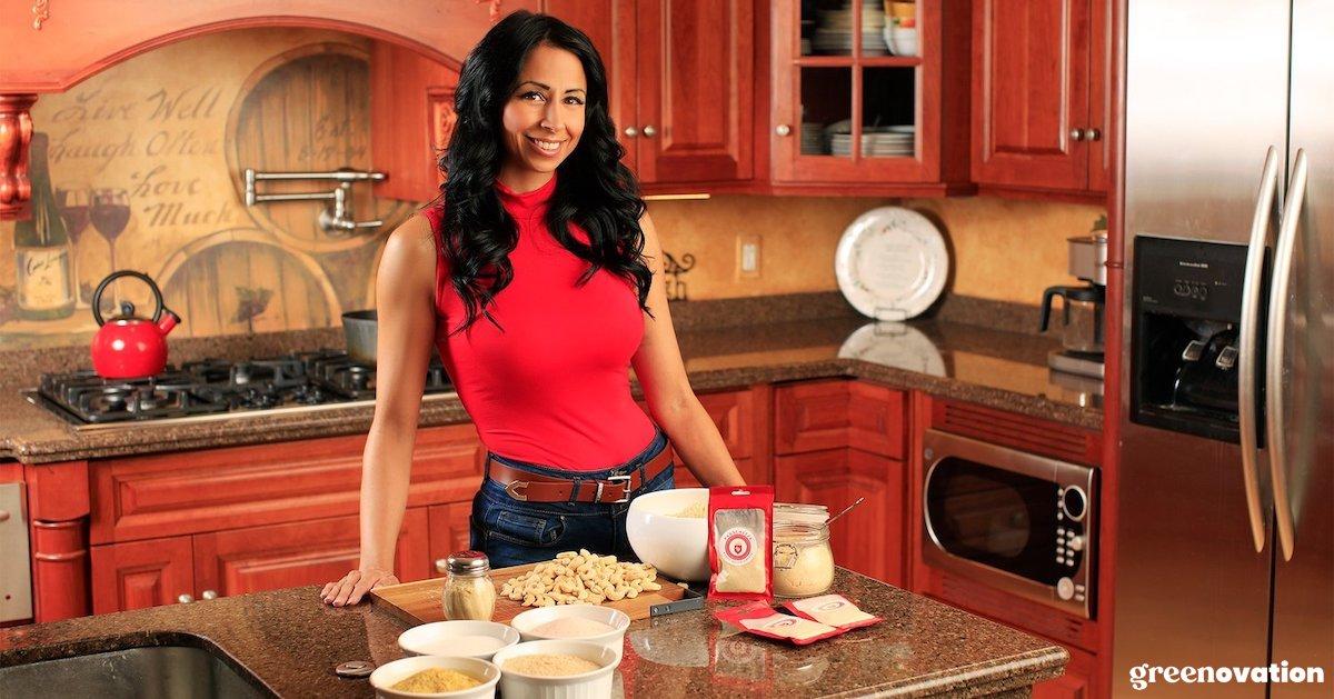 Janessa Steenberg smiles at a kitchen counter, with Panacheeza and ingredients on the counter