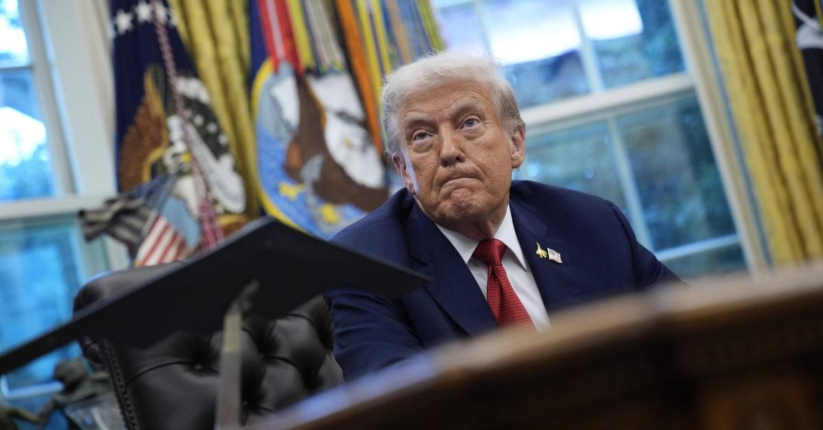 Donald Trump sitting at his desk